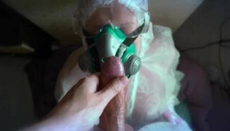 WOMAN IN A GAS MASK AND GLOVES JERKS OFF A COCK AND SUCKS. H