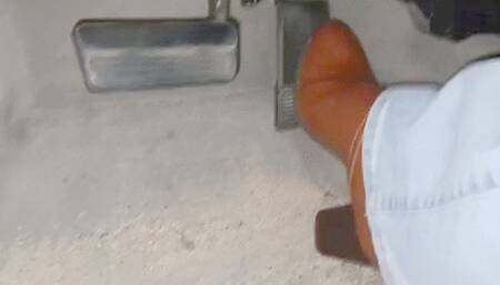 Evalynn driving in brown heeled boots 2