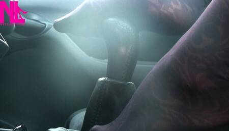 Caressing and footplaying with the wheel and the shift stick in violet patterned pantyhose