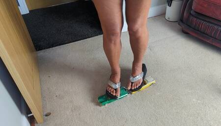 Nikkichick crushes 2 classic cars in flip flops with painted toe nails toy cars crush high left view