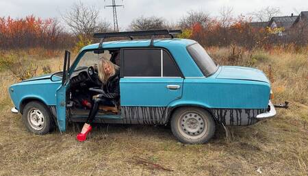 Anastasia revving old VAZ in her high heels and shiny outfit