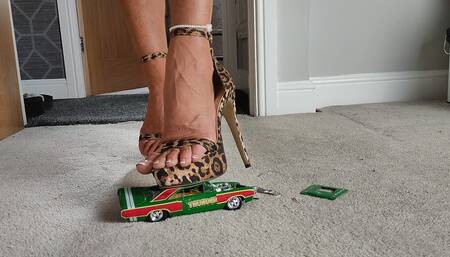 Nikkichick crushes a 1968 Dodge Dart in leopard high heels with painted toe nails toy car crush close ground view