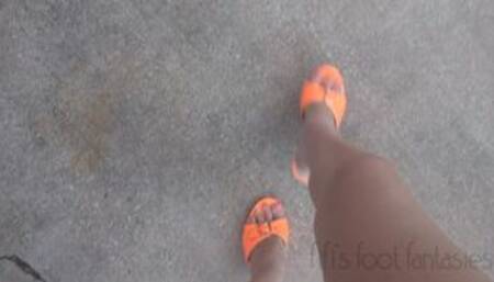 Fifi desperately cranking her old SUV in bright orange high heel stilettos with orange toenail polish while telling cranking stories