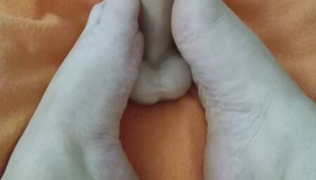 Caresses feet with oil footjob