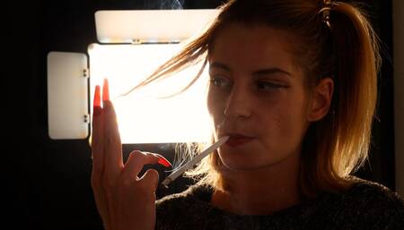 Eve’s elegant long-cigarette smoking tease and striking red nails